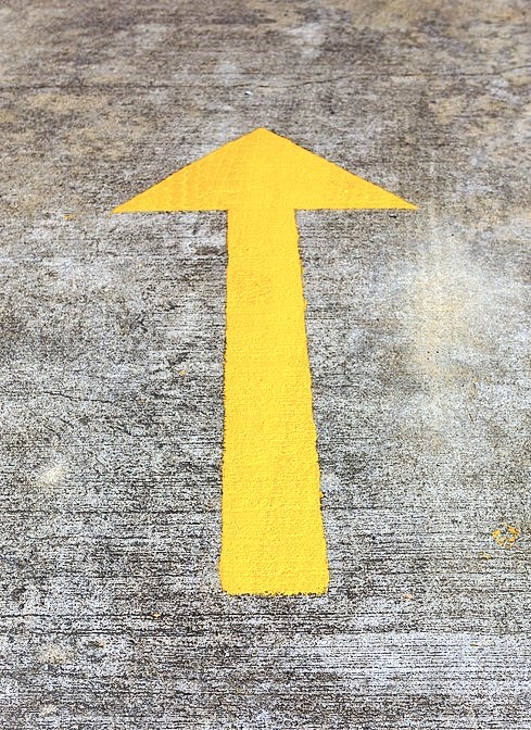 gelber Pfeil auf dem Asphalt