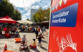 Blick auf den ludwigsplatz mit spielenden Kindern und dem Kinderkiste-Wagen